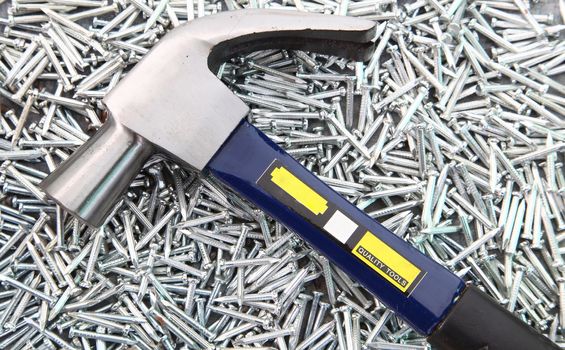 Hammer on heap of  Silver Concrete nails