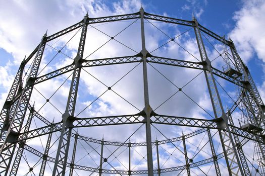 Round metal construction over cloudy sky background