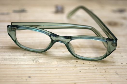 Green glasses on a wooden desk