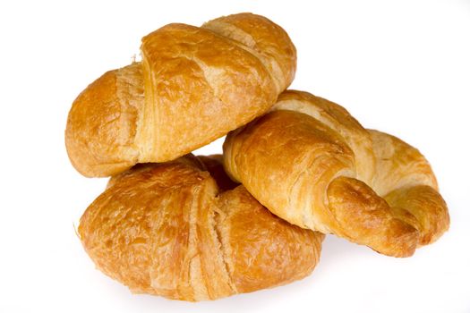 Three croissaints isolated over white background