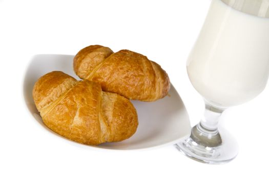 French croissants and milk over white background