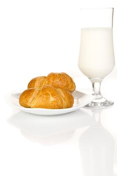French croissants and milk over white background