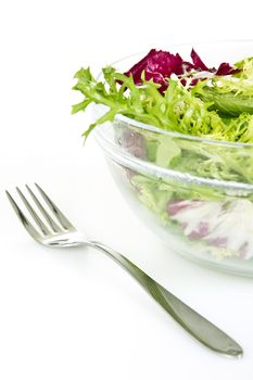 Bowl of fresh salad and fork - isolated