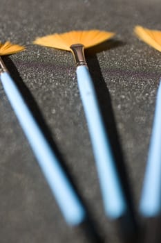 Fan shaped paintbrushes on anthracite background