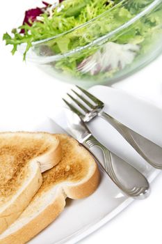 Two toasts and bowl of salad isolated over white background