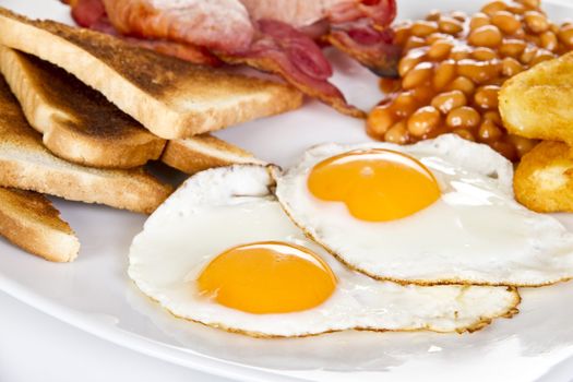 Breakfast with toasts eggs bacon beans and hash browns