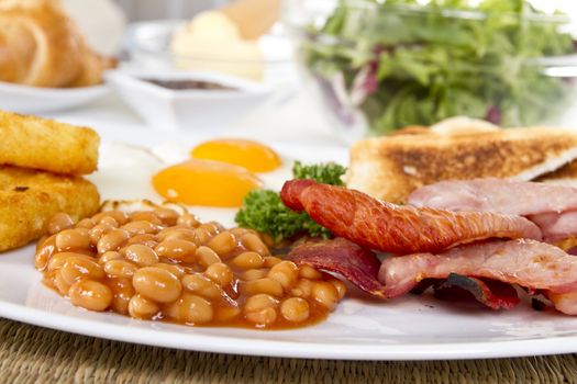 Breakfast with toasts eggs bacon beans and hash browns