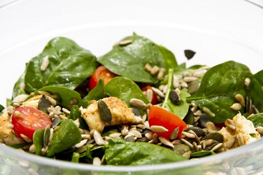 Spinach salad in transparent bowl