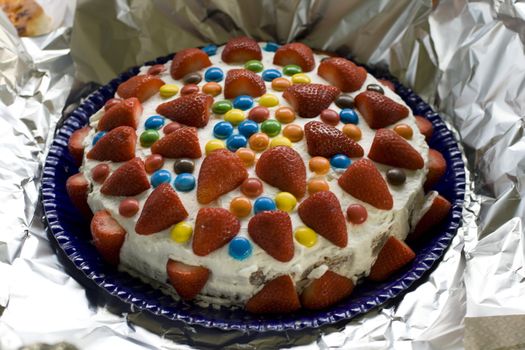 Strawberry cake with colorful candy