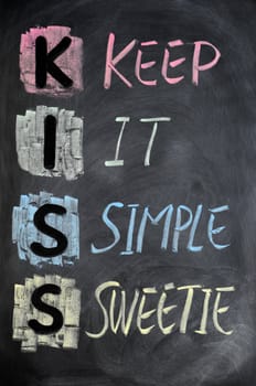 KISS acronym written in colorful chalk on a blackboard