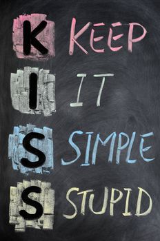 KISS acronym written in colorful chalk on a blackboard