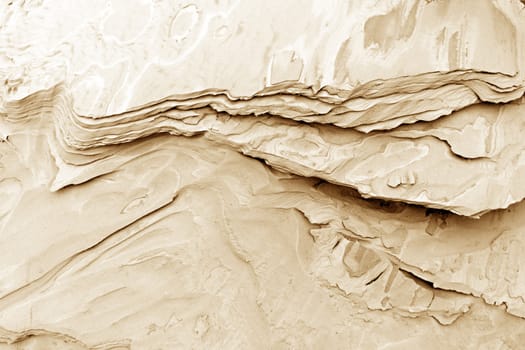 patterns of erosion of sand in the background