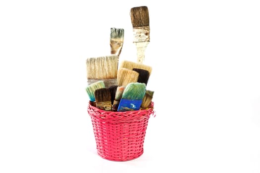Various used Paintbrushes in a wicker basket