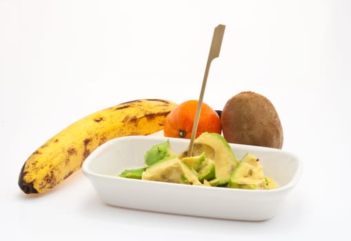 Avocado, babana, kiwi and tangerine on white