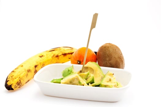 Avocado, babana, kiwi and tangerine on white