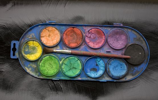 Photo of watercolors and paintbrush