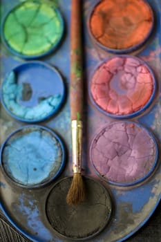 Photo of watercolors and paintbrush
