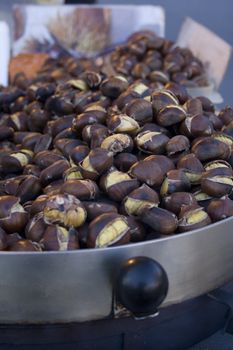 Freshly roasted chestnuts inside a iron plate
