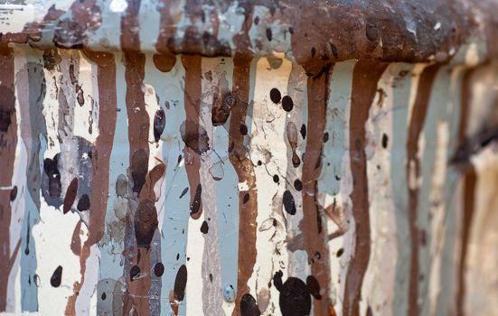 Brown and gray drippings on a dirty white background