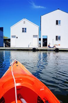 Boat house in Tacoma, WA and orange kayak.