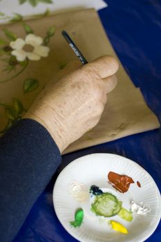 Artist painting flowers on fabric