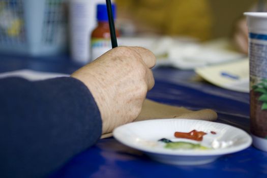 Artist painting flowers on fabric