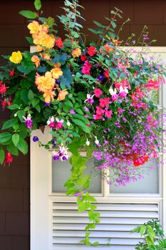 baskets with flowers outside of house windows.