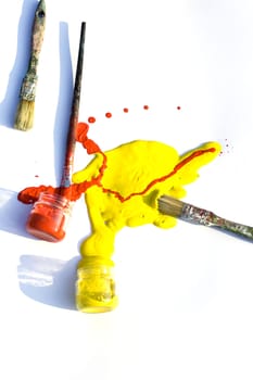 Photo of Yellow and red colors and paintbrush