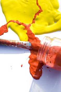 Photo of Yellow and red colors and paintbrush