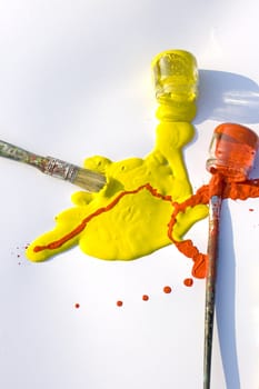 Photo of Yellow and red colors and paintbrush