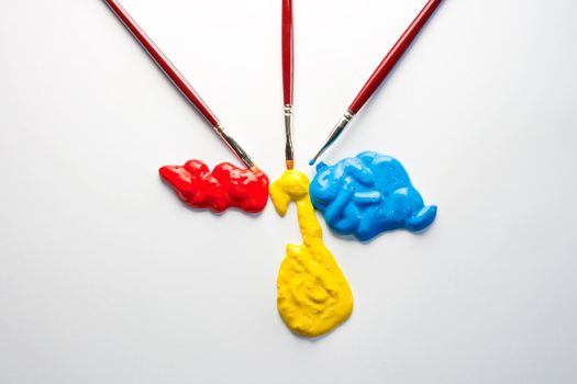 Paintbrushes with Blue, yellow and red Colors on white background
