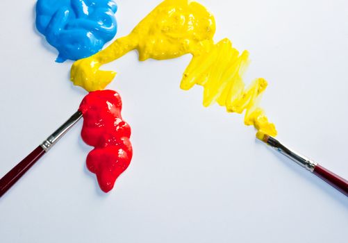 Paintbrushes with Blue, yellow and red Colors on white background