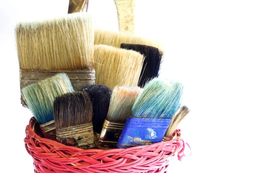 Paintbrushes inside a wicker basket