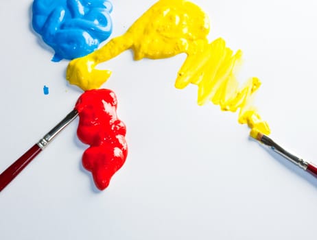 Paintbrushes with Blue, yellow and red Colors on white background