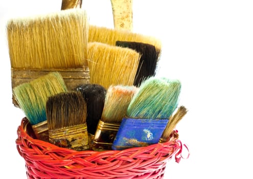Paintbrushes inside a wicker basket
