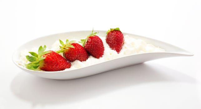 Strawberries and cream on saucer