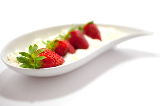 Strawberries and cream on saucer
