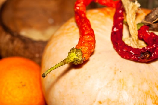 Close up of red hot Chili peppers on pumpkin