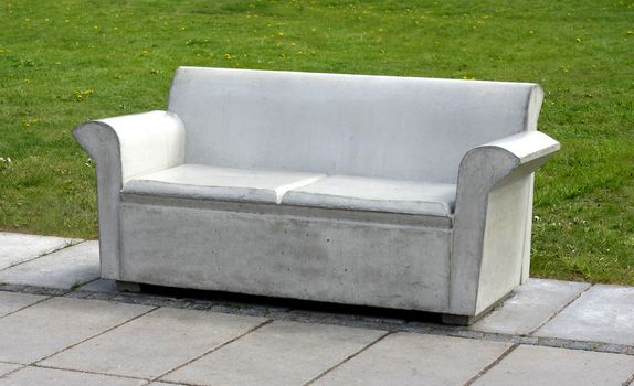 Concrete sofa in park, symbol for uncomfortability.