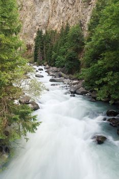 Dora stream between rocks in Pre Saint Didier, Aosta. Italy