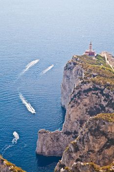 Panorama with Capri lighthouse and boats during a sunny day