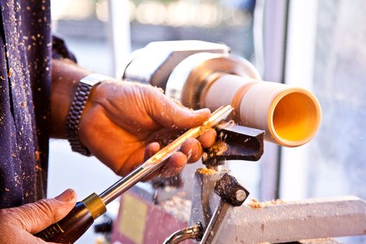 Old worker hands at lathe
