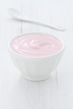 Fresh, healthy and delicious creamy, strawberry yogurt in vintage French cup, the perfect snack or dessert.