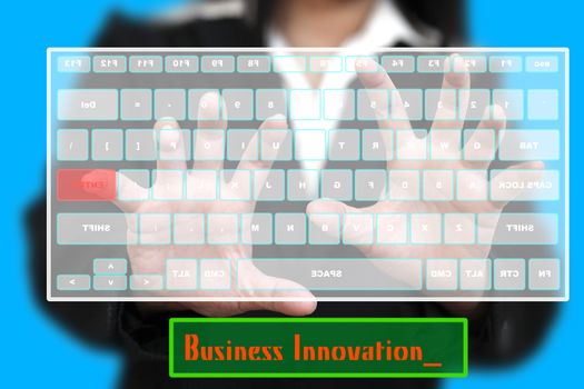 BusinessWoman typing Business Innovation on Virtual Keyboard (selective focus at Hand)