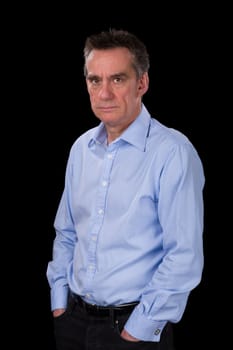 Angry Frowning Middle Age Business Man in Blue Shirt Black Background
