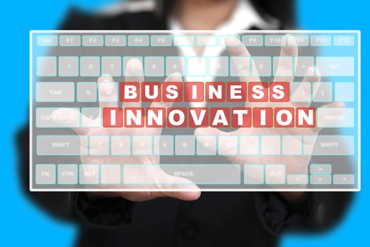 Business Woman typing Business Innovation on Virtual Keyboard
