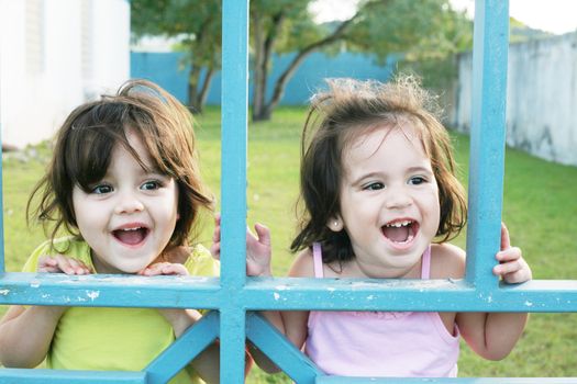 Portrait of happy two sisters outdoors having fun