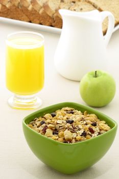 delicious breakfast with whole grain bread,fresh green apple and a healthy bowl of cereal.