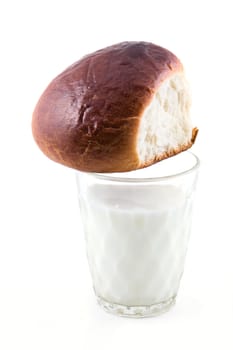 Rich roll and milk in a glass on a white background