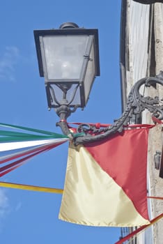 Sicilian flag and street lamp on the wall, Sicily, Italy